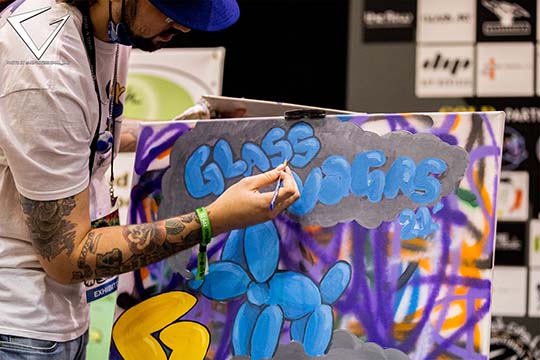 2021 - Painter on Stage with sponsors in backgroun