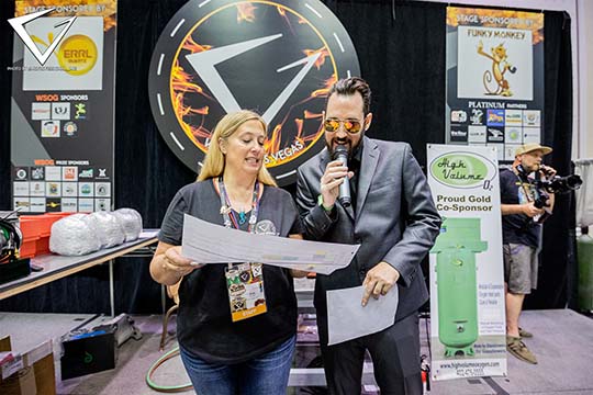 2021 - Jen and Shelbo on Stage with Sponsor Logos